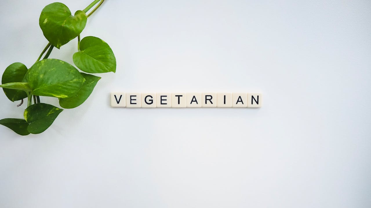 home-hero A simple and fresh vegetarian concept featuring green leaves and tiles spelling VEGETARIAN.