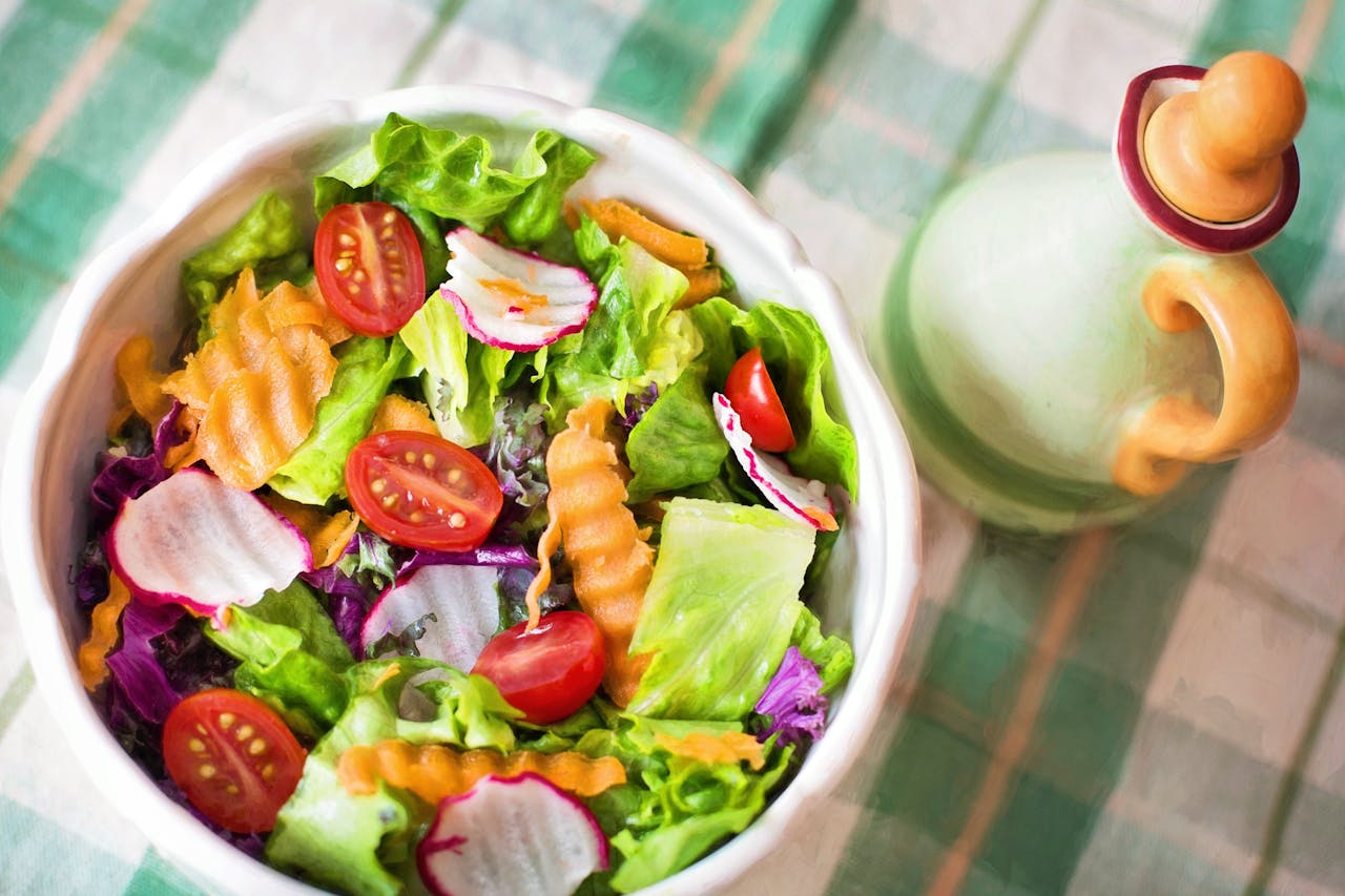 services-02 Colorful fresh vegetable salad with cherry tomatoes in a white bowl.